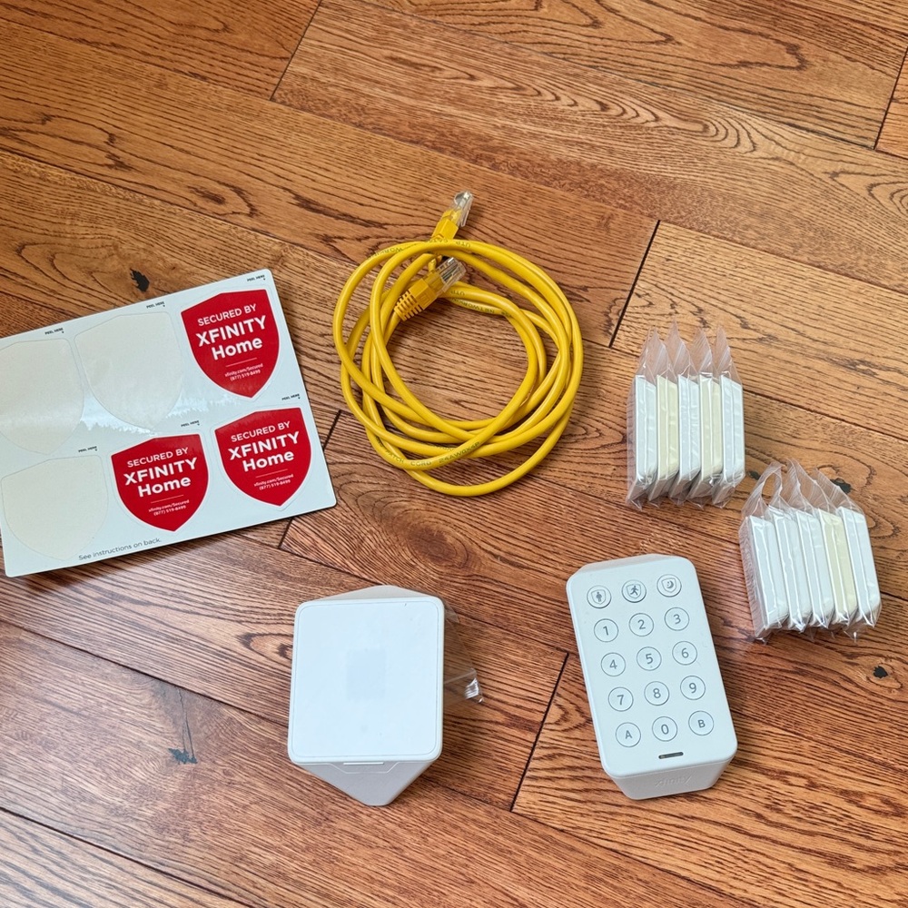 Xfinity Home Security System with White Keypad and Yellow Cable